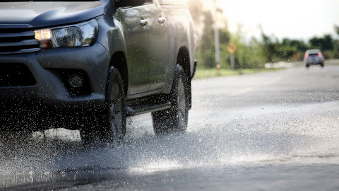 Car Driving Through Puddle