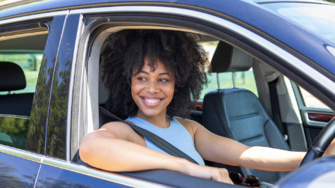 Woman Sitting In Car With Window Down
