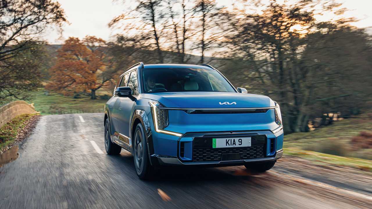 Blue KIA EV9 driving in the country side