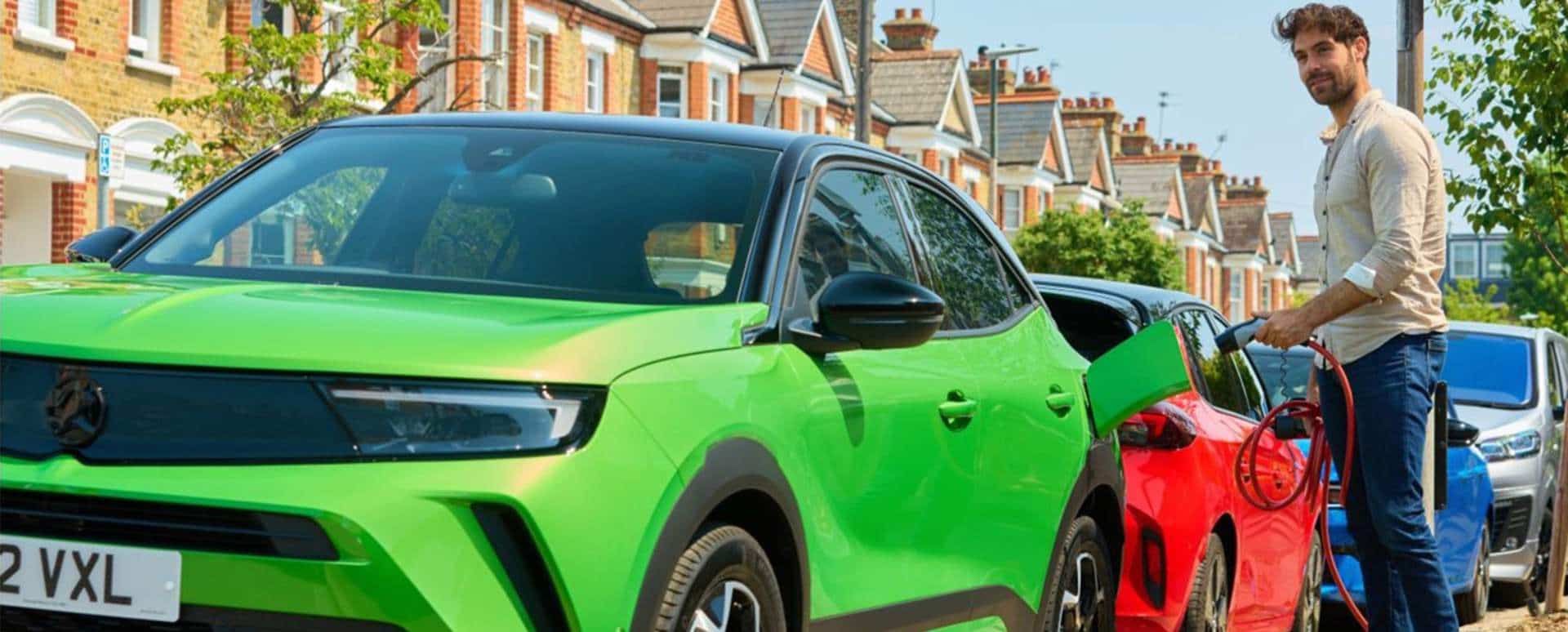 Man charging a Vauxhall Mokka in the street