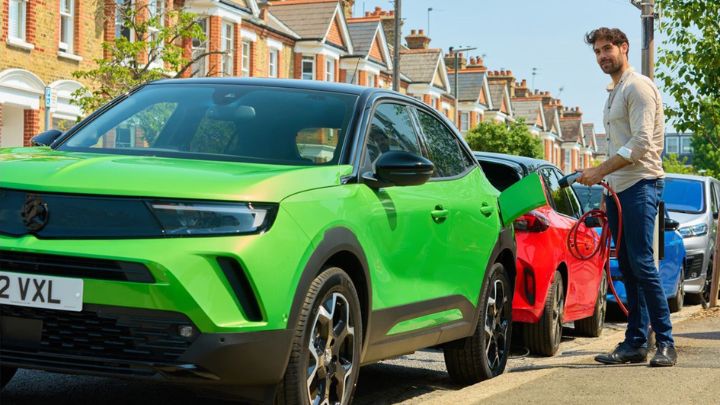 Man charging a Vauxhall Mokka in the street