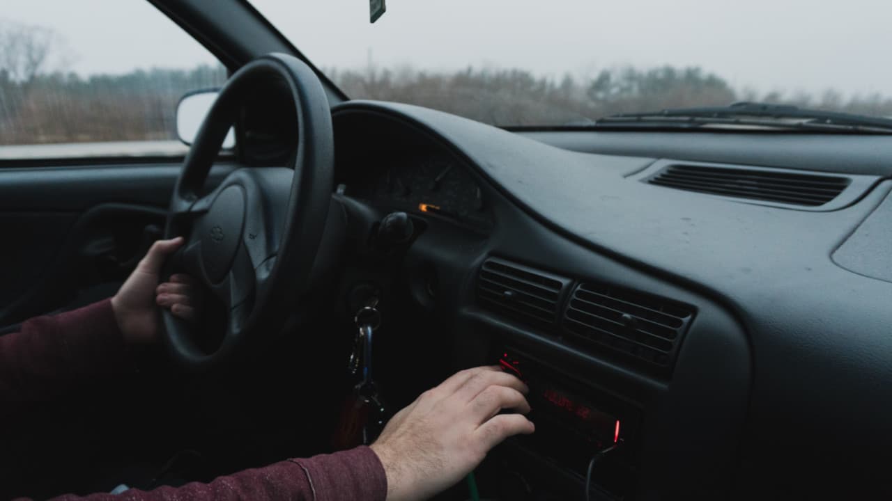 Driver Adjusting Dashboard Controls Car