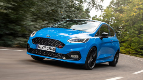 Blue Ford Fiesta ST Edition Exterior Front Driving on Forest Road