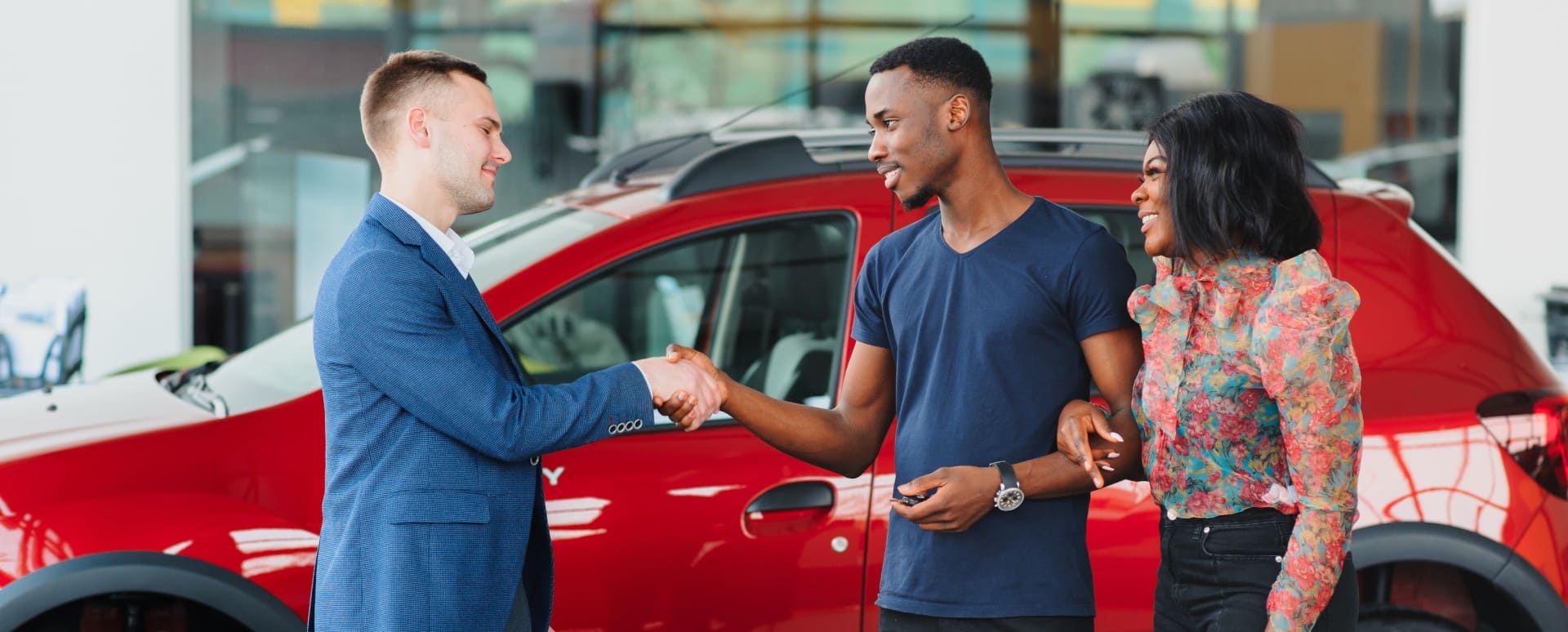 Shaking Hands In Front of Car