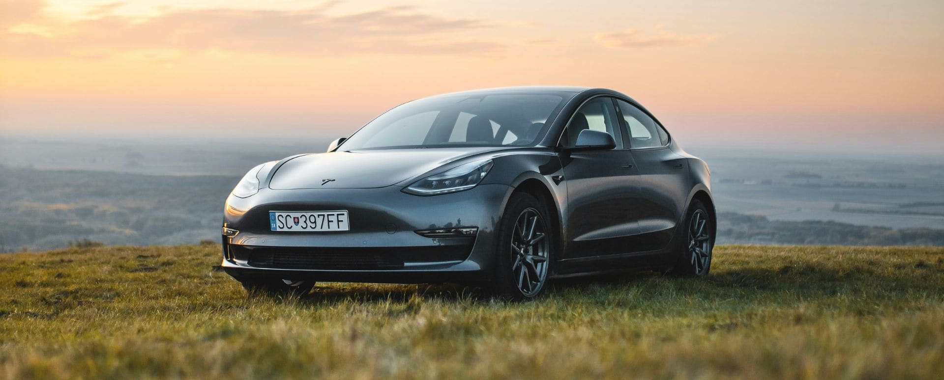 Tesla parked in the countryside