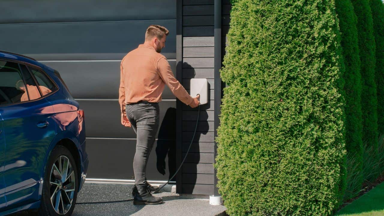 Man turning on his EV home charger