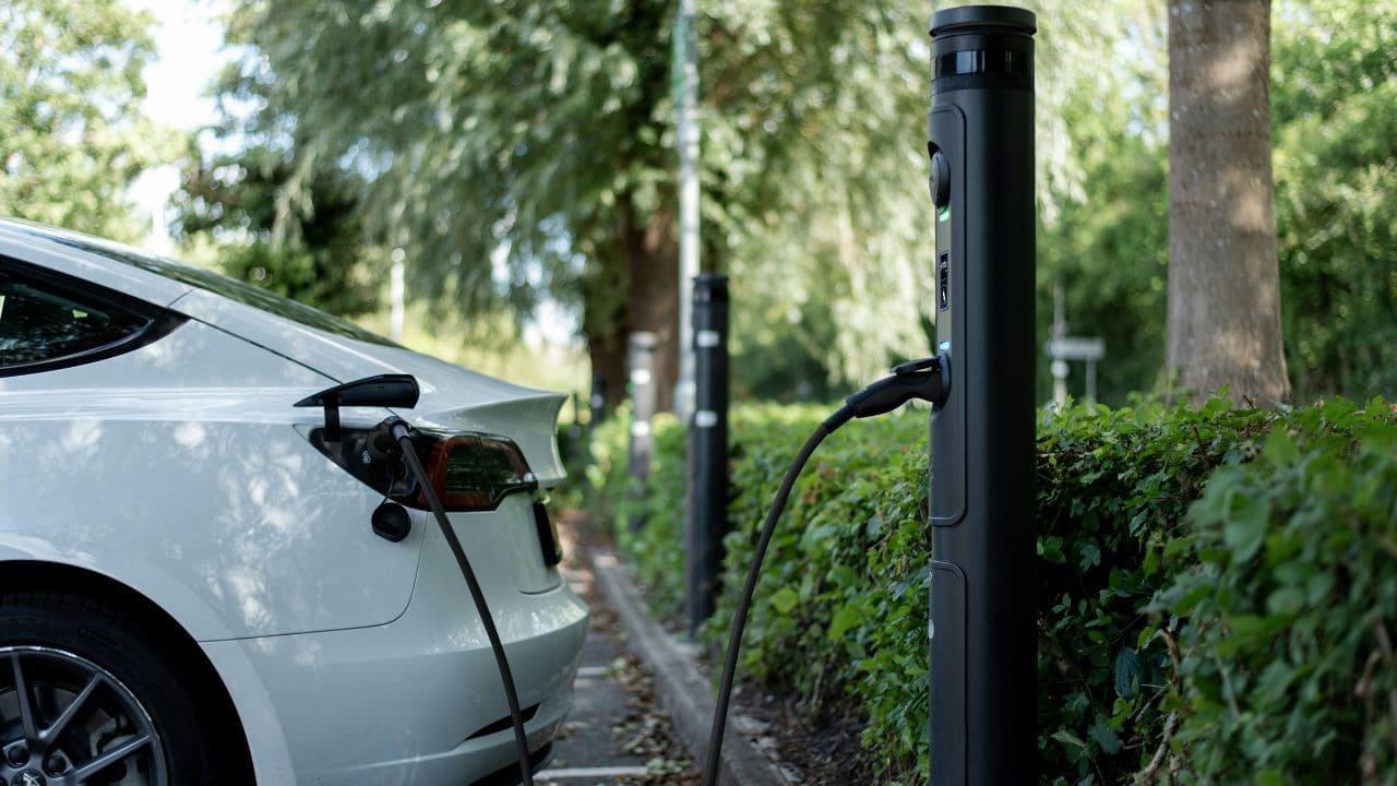 White EV being charged in a public charging station