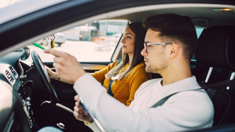 Woman Driving Car With Man in the Passenger Seat