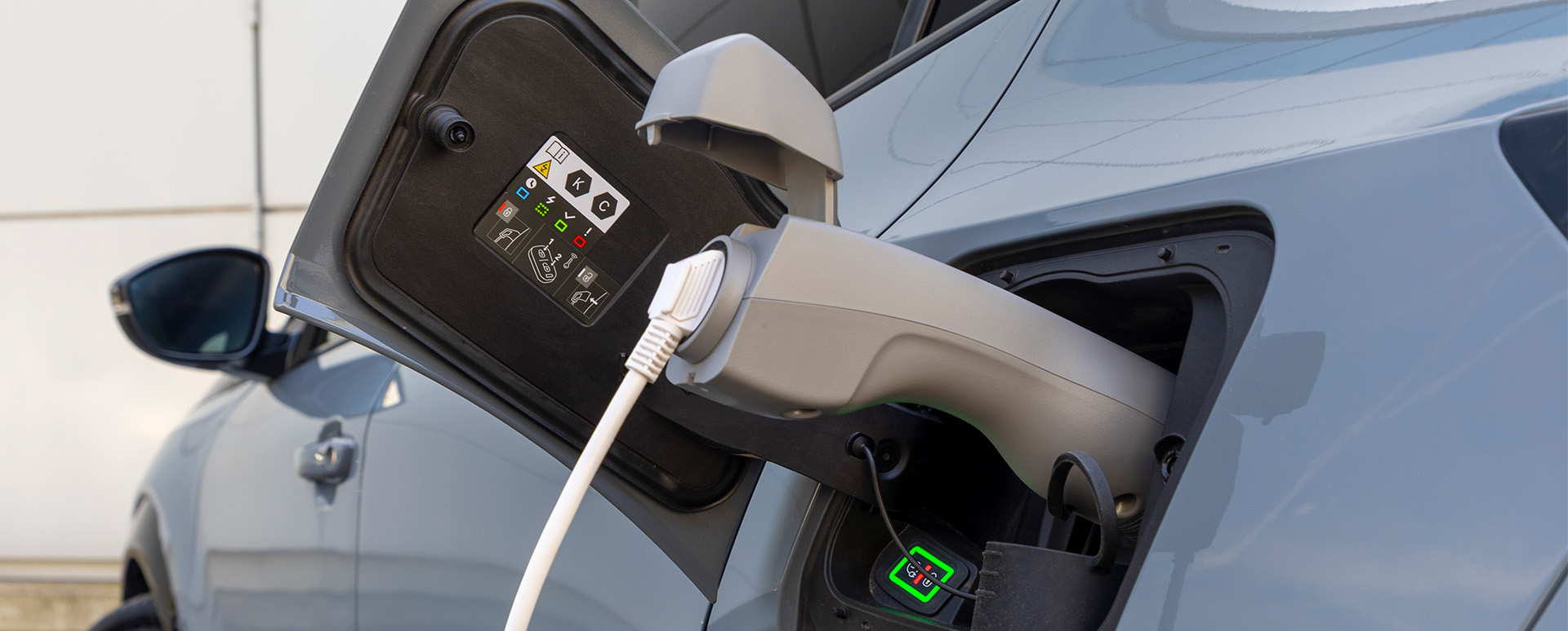 V2L Charger plugged into grey car