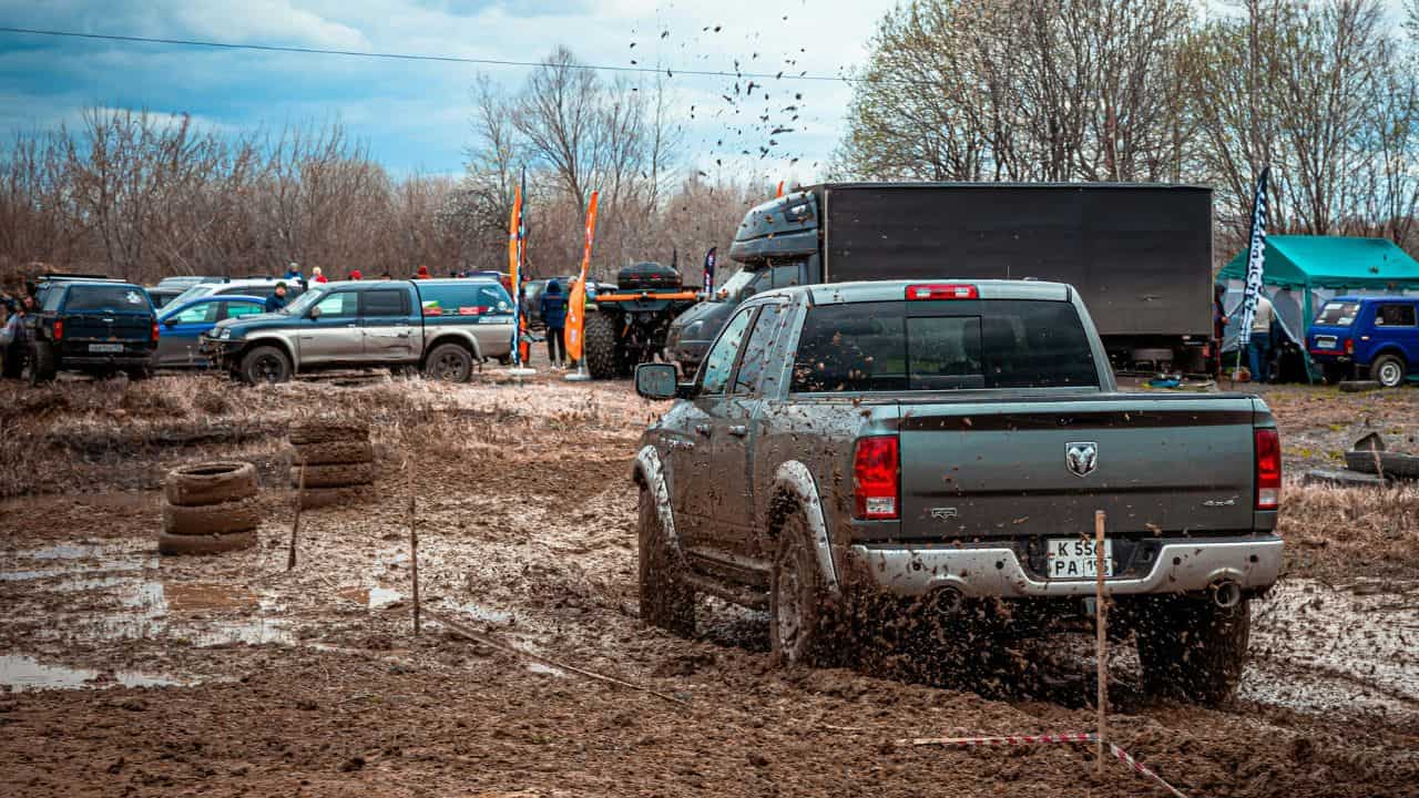 Cars parked in a muddy camping site