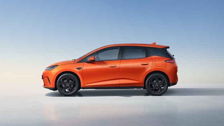 BYD Dolphin G DM-i electric hatchback in orange, side profile in clean studio setting