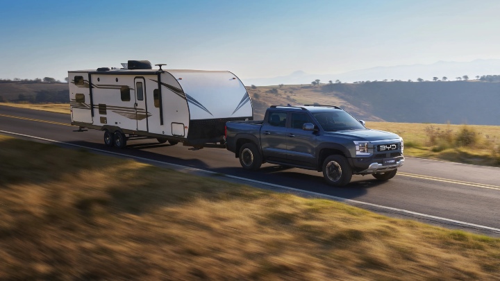 Blue BYD Shark towing caravan