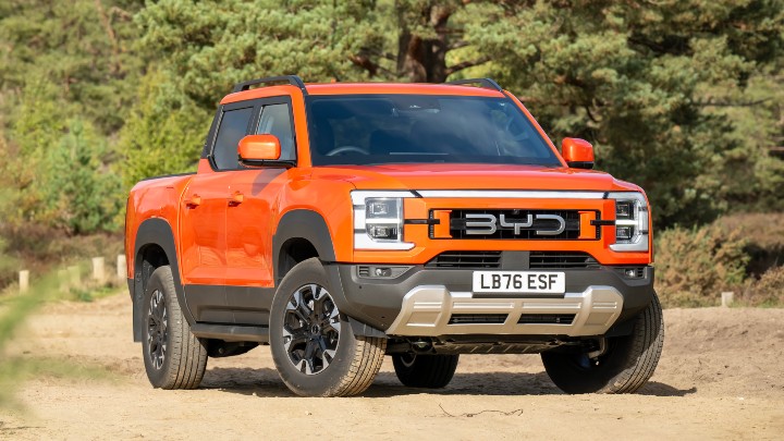 Orange BYD Shark Parked On Dust Road