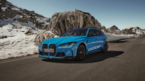 Blue BMW M3 Touring Exterior Front Driving Mountains