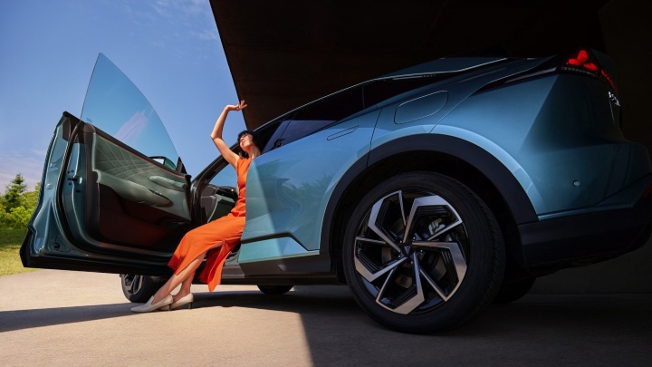Woman Exiting a Changan Deepal S07 in half and half sunlight and shade
