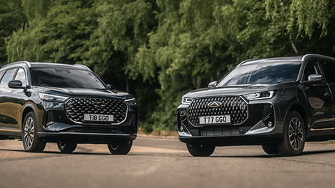 Two Black Chery Vehicles Parked in Countryside