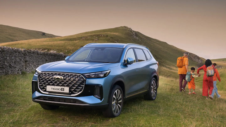 Blue Chery Tiggo 8 Parked in Field with Family