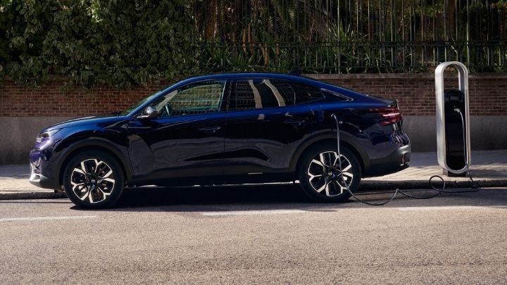 Blue Citroen e-C4 parked on the kerb whilst being charged