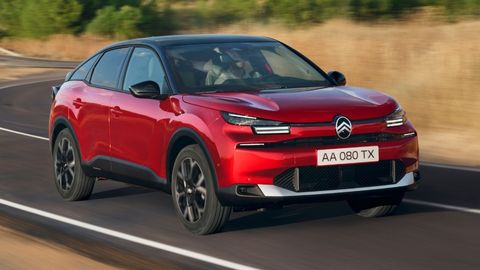 Red Citroen e-C4 driving on the motorway in the countryside