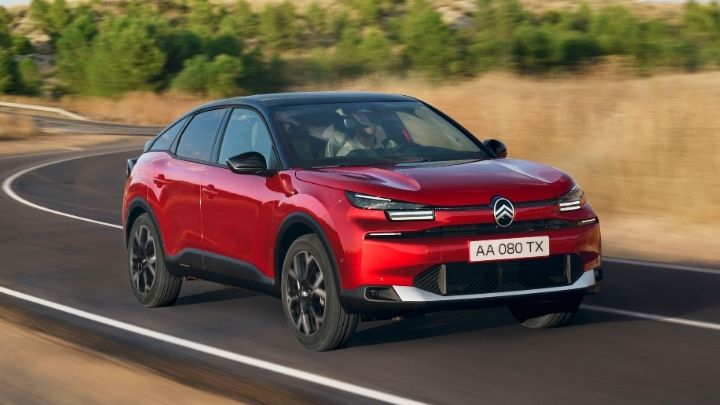 Red Citroen e-C4 driving on the motorway in the countryside