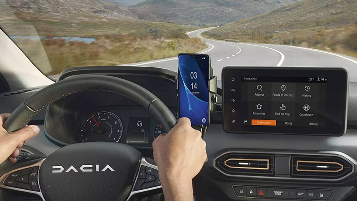 Point of view shot of someone driving from behind the steering wheel of a Dacia Jogger