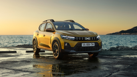 Dacia Sandero Stepway in yellow parked in front of ocean