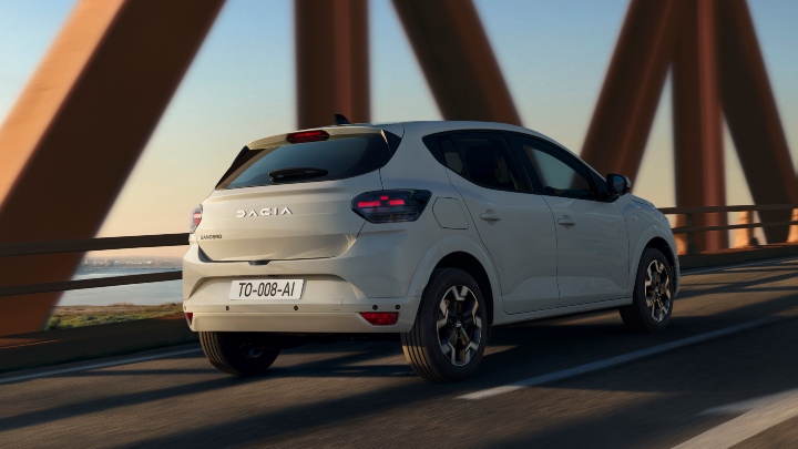 White Dacia Sandero Exterior Rear Driving on Bridge