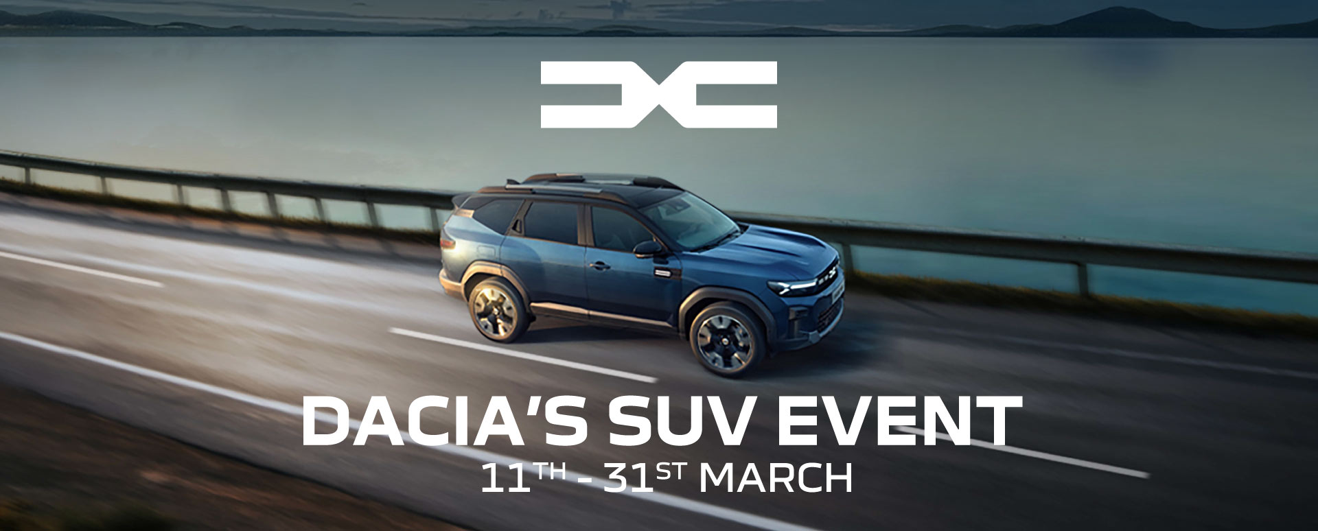 Blue Dacia Driving Across Highway Bridge With Promotional Messaging