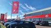 Exterior shot of an MG dealership in Grantham, with cars parked out front, and the MG flag flying above