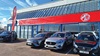 Exterior shot of an MG dealership in Grantham, with cars parked out front the main entrance