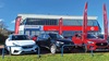 Exterior shot of an MG dealership in Grantham, with cars parked out front on the pitch, with the building in the background
