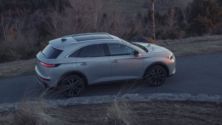 Silver DS 7 in a countryside road