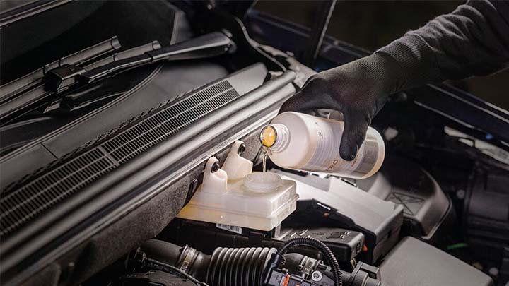 technician topping up ds engine fluids