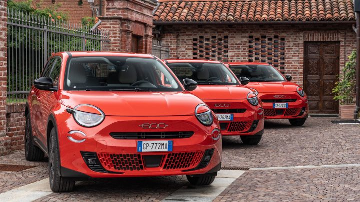 Trio of Red Fiat 600e Cars on Driveway