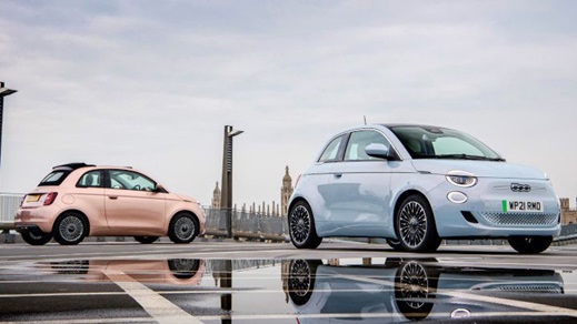 Pink and blue Fiat 500 parked in front of the Palace of Westminster in London