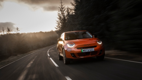 Red Fiat 600e Exterior Front Driving on Forest Road