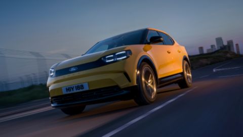 Yellow Ford Capri driving on the road
