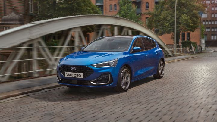 Blue Ford Focus driving on the road