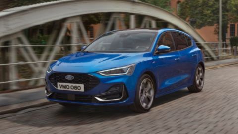 Blue Ford Focus driving on the road