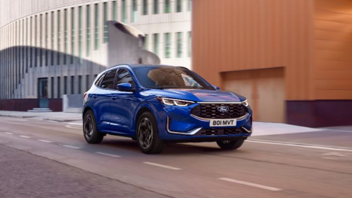 Blue Ford Kuga driving on the road