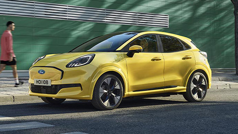 Yellow Ford Puma Gen-E Driving On Road