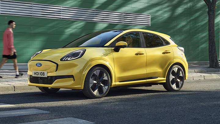 Yellow Ford Puma Gen-E Driving On Road