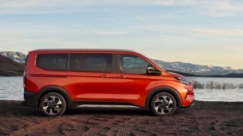 Side Exterior of an Orange Ford Tourneo Custom on the Shore of a Lake