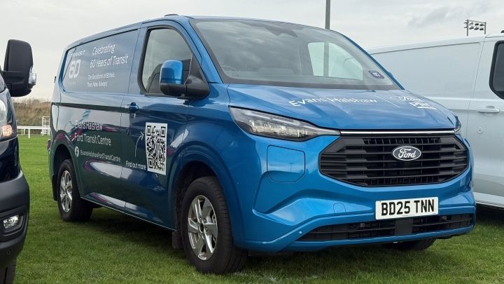 Blue Ford Transit with Evans Halshaw stickers around it parked in a grass car park