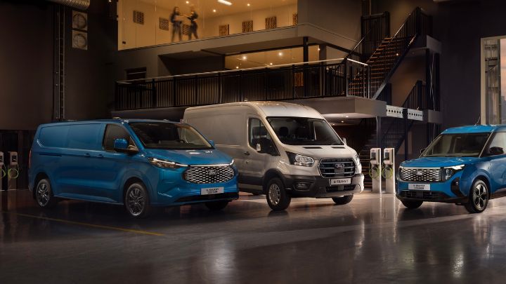 2 Ford Electric vans charging outside office building