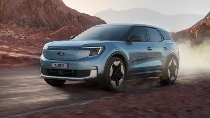 Pale Blue Ford Explorer Driving in Dusty Environment