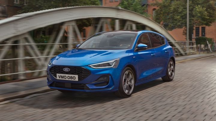 Blue Ford Focus Driving on Bridge