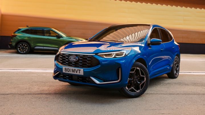 Blue Ford Kuga Driving on Road with Green Ford in Background