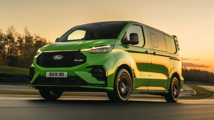 Green Ford Van Driving on Quiet Road Low Angle