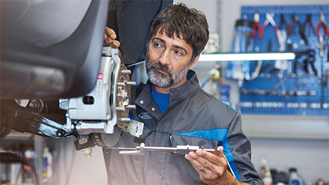Ford technician completing some repairs on car brakes